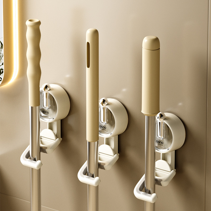 Cream colored heavy-duty suction cup mop holder mounted on a smooth glazed tile wall